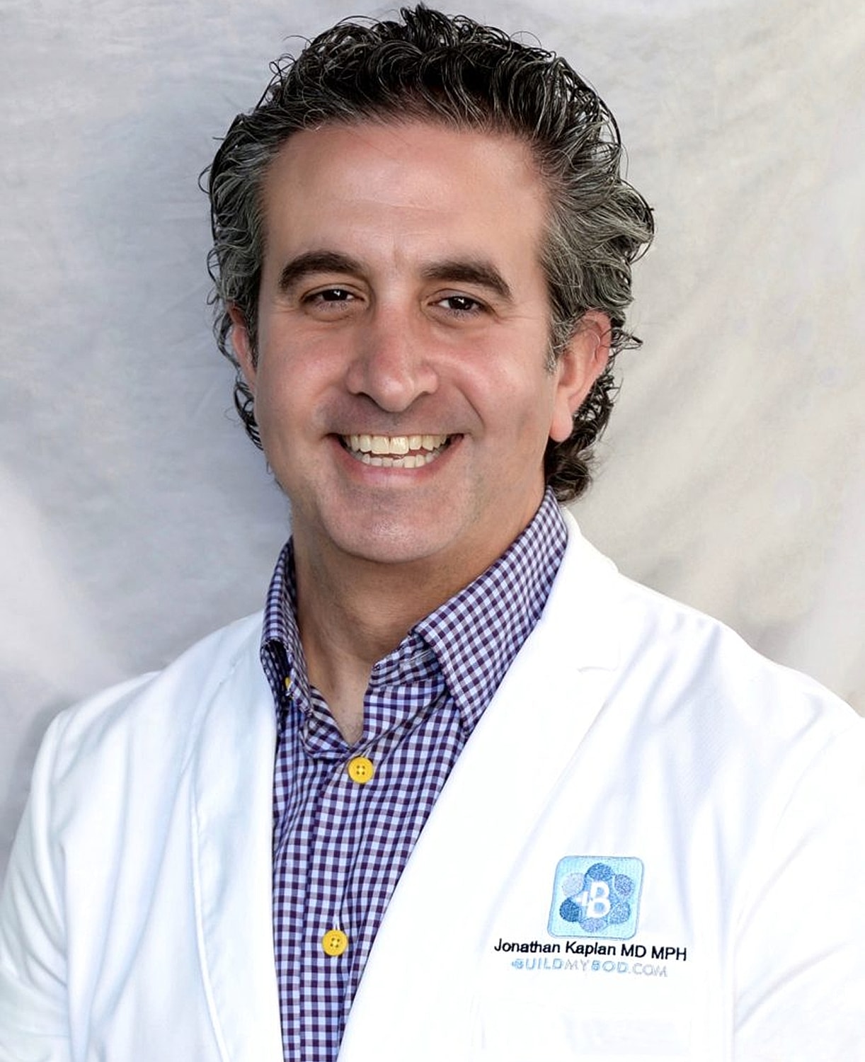 Smiling doctor in white coat portrait photo.