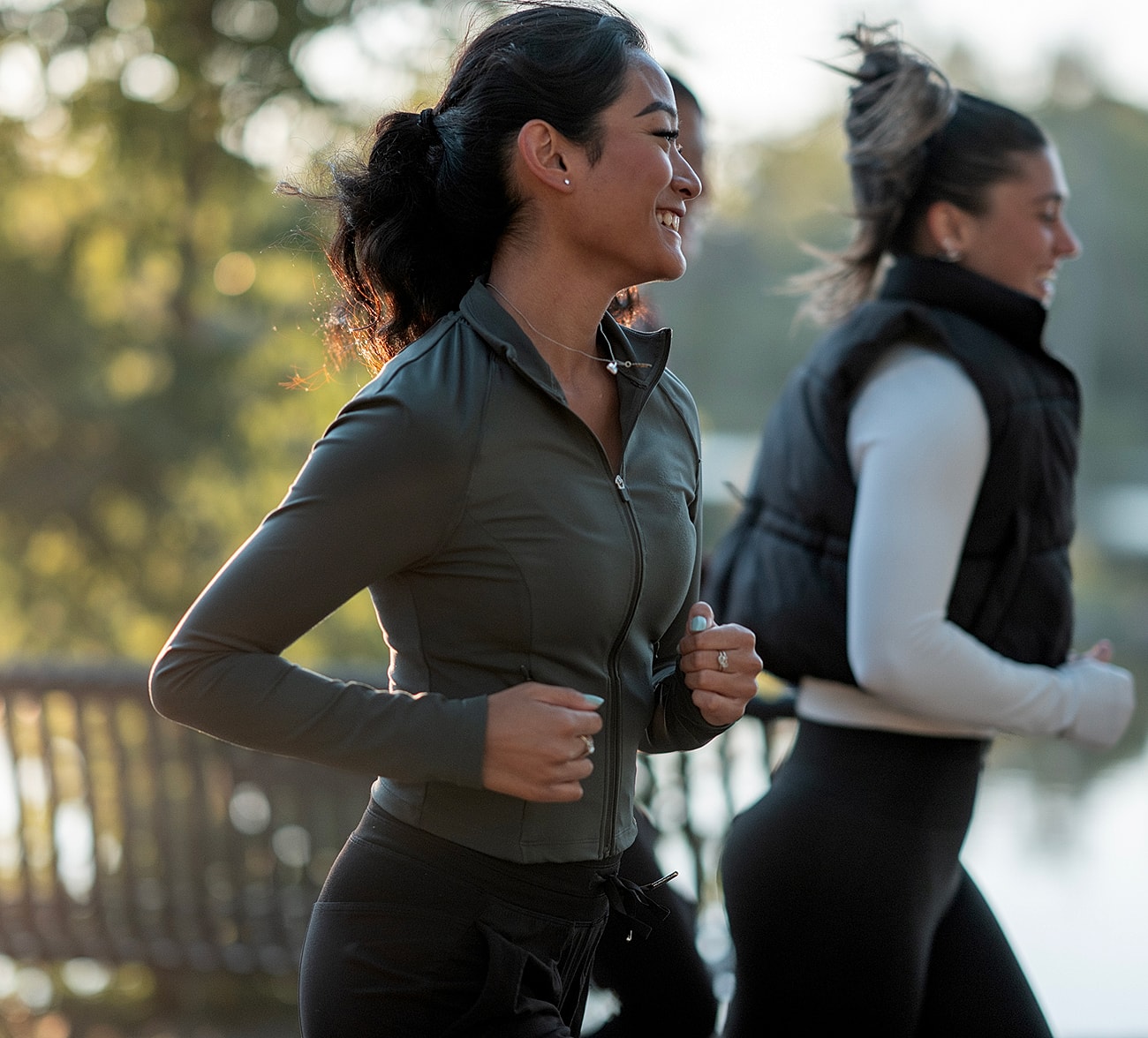 Women jogging outdoors in athletic wear.