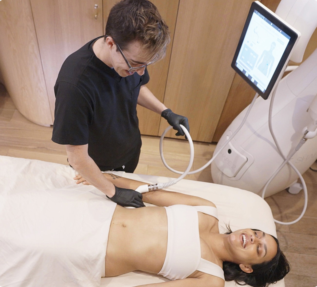 Spa treatment with practitioner using medical equipment.