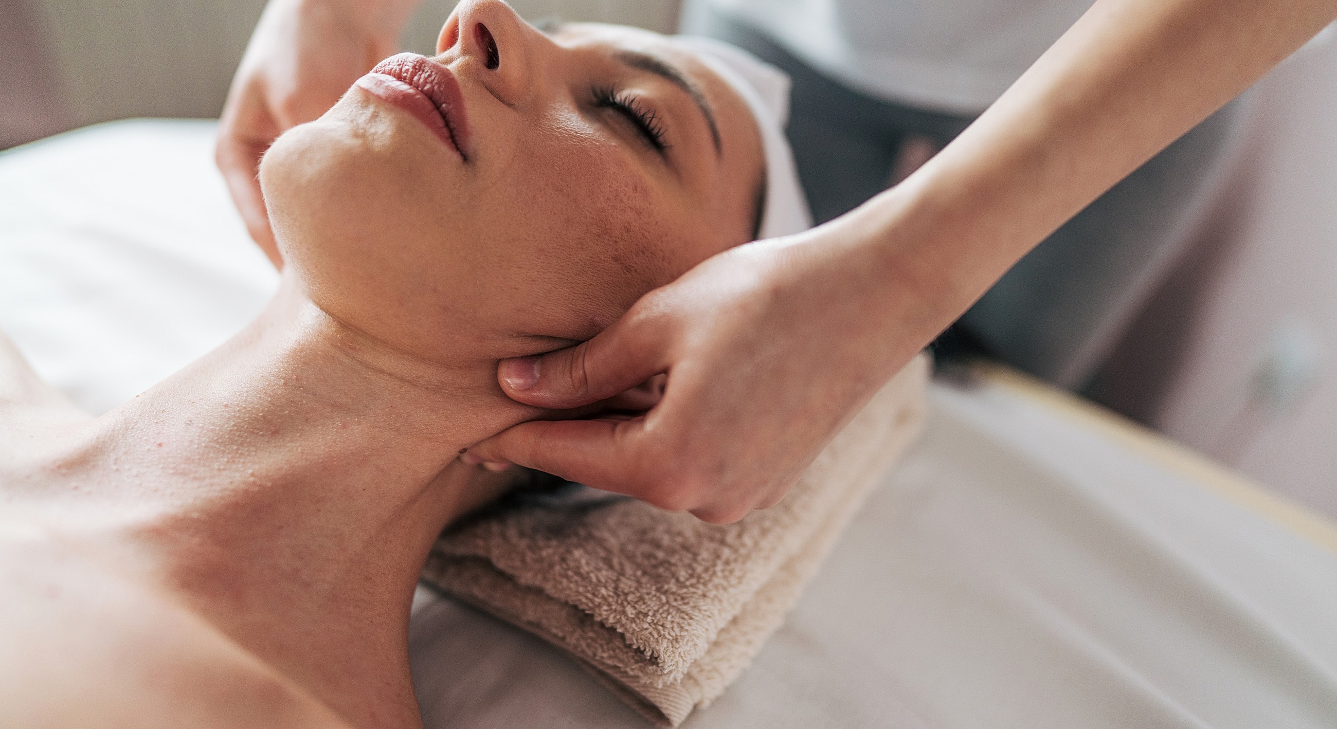 Facial massage in a calming spa setting.