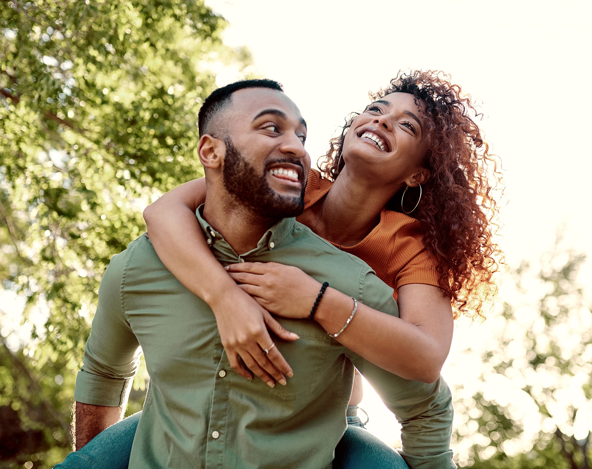 Happy couple enjoying a playful moment outdoors.
