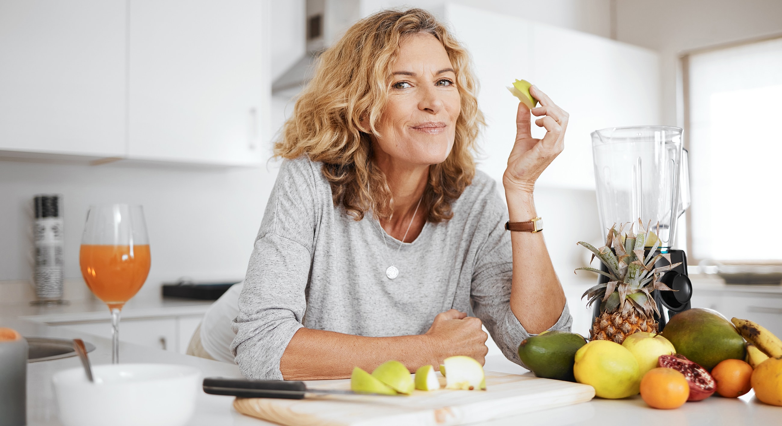 Woman enjoying healthy snacks in kitchen.